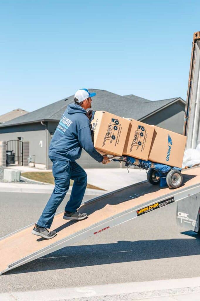 Larsen Transfer local movers carrying boxes to the truck